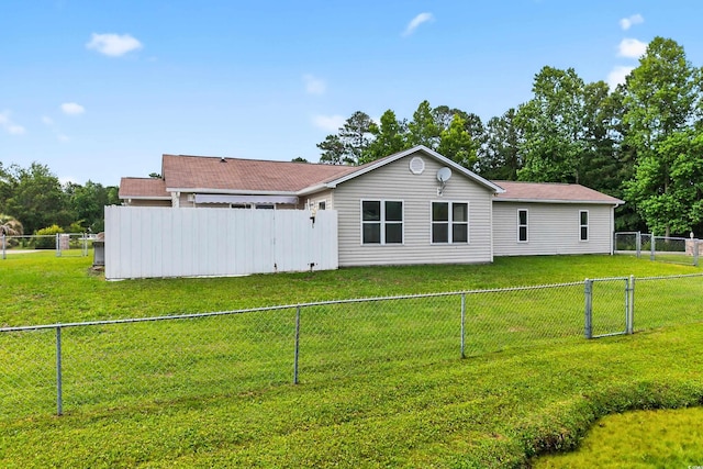131 Pine Lake Cir, Ocean Isle Beach, NC 28469 - back of house featuring a fenced backyard and a gate