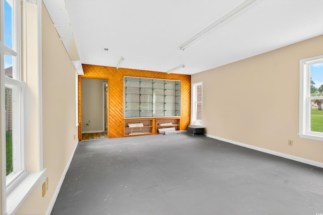 131 Pine Lake Cir, Ocean Isle Beach, NC 28469 - unfurnished room with wooden walls and concrete floors