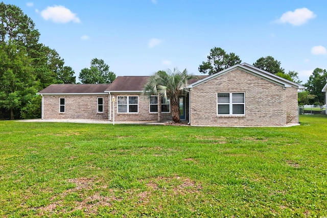131 Pine Lake Cir, Ocean Isle Beach, NC 28469 - view of front facade with brick siding and a front lawn