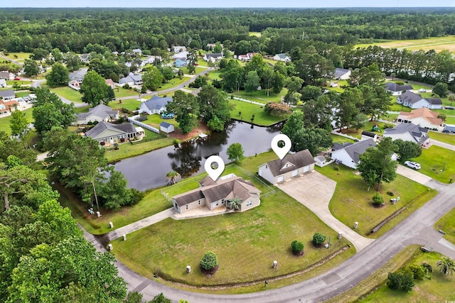 131 Pine Lake Cir, Ocean Isle Beach, NC 28469 - aerial view of residential area with a large body of water and a heavily wooded area
