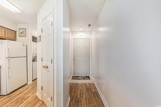 537 White River Dr Unit 17C, Myrtle Beach, SC 29579 - corridor with stacked washer / drying machine and light wood-style flooring