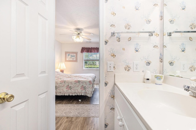 537 White River Dr Unit 17C, Myrtle Beach, SC 29579 - ensuite bathroom with vanity, wood finished floors, and a ceiling fan