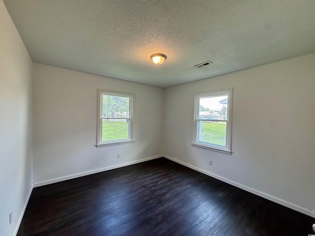 109 S Maple Ave, Andrews, SC 29510 - spare room with dark wood-style floors and a textured ceiling