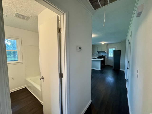 109 S Maple Ave, Andrews, SC 29510 - corridor with dark wood-type flooring, a textured ceiling, and attic access