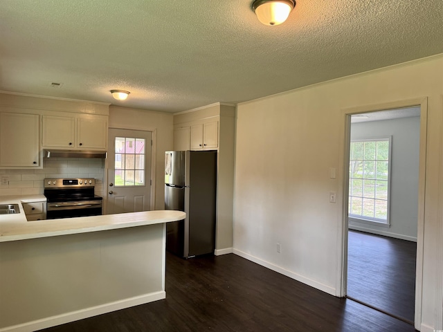 109 S Maple Ave, Andrews, SC 29510 - kitchen featuring stainless steel appliances, under cabinet range hood, a textured ceiling, dark wood-style floors, and tasteful backsplash