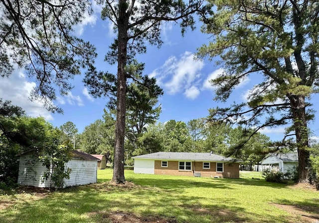 109 S Maple Ave, Andrews, SC 29510 - view of green lawn featuring an outdoor structure
