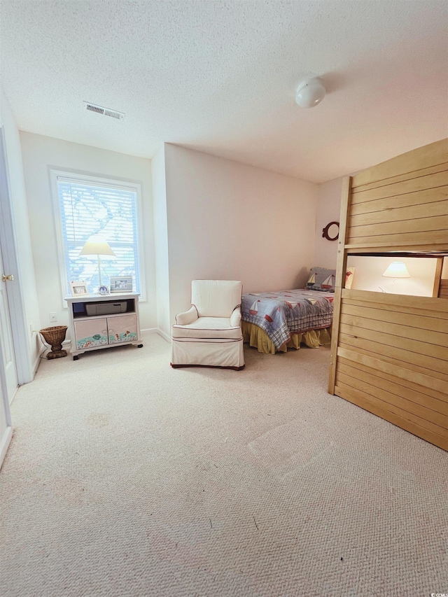 140 S Cove Pl Unit 6C, Pawleys Island, SC 29585 - carpeted bedroom with a textured ceiling and baseboards
