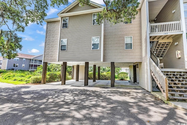 140 S Cove Pl Unit 6C, Pawleys Island, SC 29585 - view of front of house with stairs, a carport, and asphalt driveway