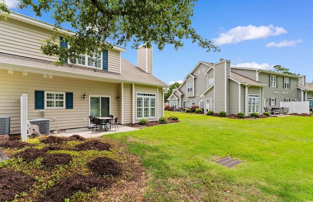 503 20th Ave N Unit 29-C, North Myrtle Beach, SC 29582 - rear view of property with a patio area, a yard, and a chimney