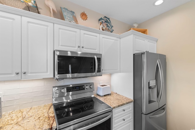 503 20th Ave N Unit 29-C, North Myrtle Beach, SC 29582 - kitchen featuring appliances with stainless steel finishes, decorative backsplash, white cabinets, recessed lighting, and light stone counters
