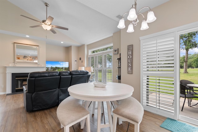 503 20th Ave N Unit 29-C, North Myrtle Beach, SC 29582 - dining room with vaulted ceiling, light wood-style floors, ceiling fan, a chandelier, and a fireplace with flush hearth