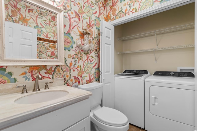 503 20th Ave N Unit 29-C, North Myrtle Beach, SC 29582 - bathroom with wallpapered walls, washing machine and dryer, and vanity