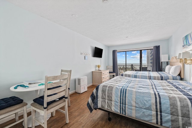 2000 S Ocean Blvd Unit V405, Myrtle Beach, SC 29577 - bedroom featuring a textured ceiling and wood finished floors