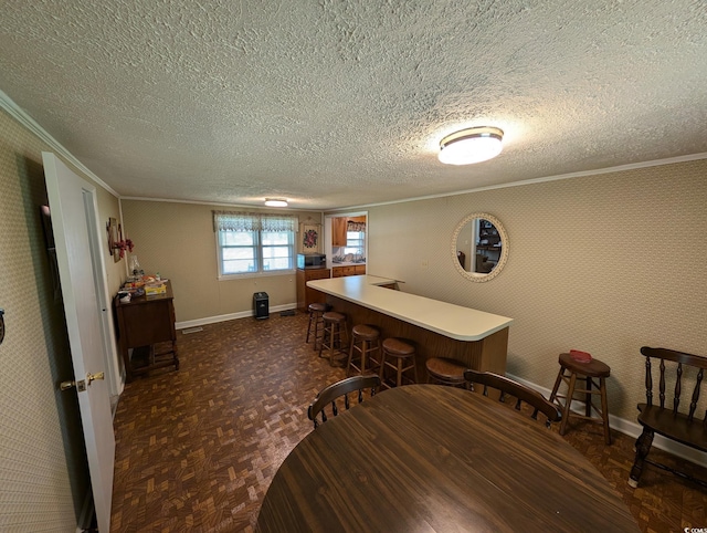 5370 Miracle Ln, Conway, SC 29526 - dining room with crown molding, a textured ceiling, and a bar