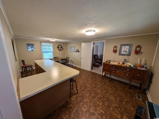 5370 Miracle Ln, Conway, SC 29526 - kitchen with ornamental molding, a kitchen breakfast bar, and a textured ceiling