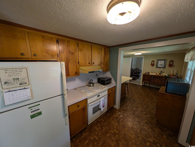 5370 Miracle Ln, Conway, SC 29526 - kitchen with white appliances, brown cabinets, a textured ceiling, light countertops, and under cabinet range hood