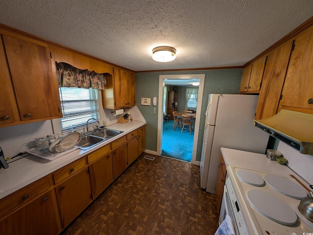 5370 Miracle Ln, Conway, SC 29526 - kitchen featuring light countertops, a textured ceiling, brown cabinetry, crown molding, and freestanding refrigerator