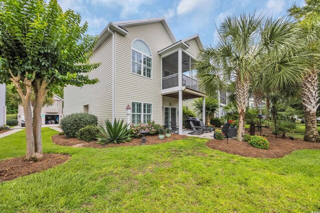 1413 Cottage Cove Cir N, Myrtle Beach, SC 29582 - back of house featuring a balcony, a yard, a patio area, and a ceiling fan