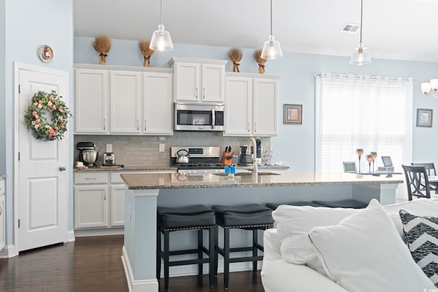 308 Firenze Loop, Myrtle Beach, SC 29579 - kitchen featuring stainless steel appliances, backsplash, and white cabinetry