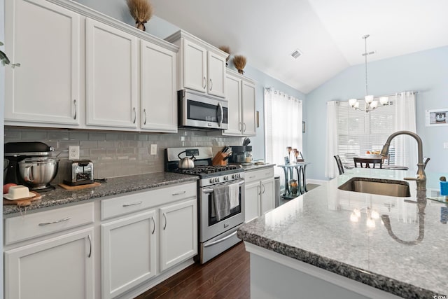 308 Firenze Loop, Myrtle Beach, SC 29579 - kitchen featuring stainless steel appliances, lofted ceiling, dark wood-type flooring, white cabinets, and a chandelier