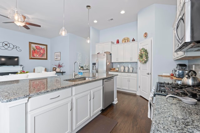 308 Firenze Loop, Myrtle Beach, SC 29579 - kitchen featuring stainless steel appliances, ceiling fan, decorative backsplash, white cabinetry, and dark wood-style floors