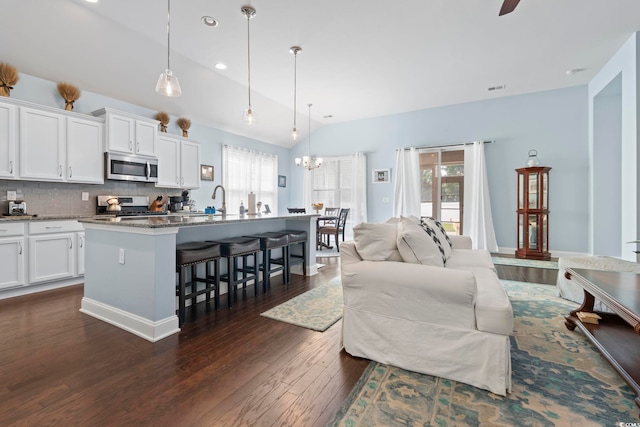 308 Firenze Loop, Myrtle Beach, SC 29579 - living room with plenty of natural light, dark wood-style floors, lofted ceiling, recessed lighting, and a chandelier
