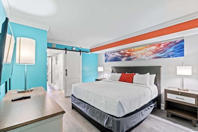 7200 N Ocean Blvd Unit 257, Myrtle Beach, SC 29572 - bedroom featuring a barn door and light wood-type flooring