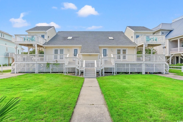 4806 S Ocean Blvd, Surfside Beach, SC 29575 - back of house with a lawn, a deck, and roof with shingles