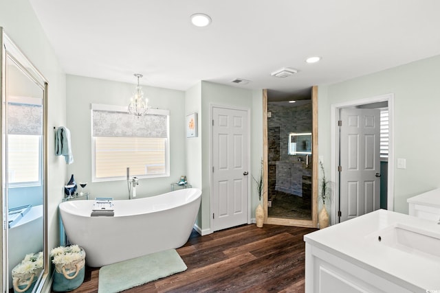 4806 S Ocean Blvd, Surfside Beach, SC 29575 - full bathroom featuring a shower stall, wood finished floors, a freestanding tub, vanity, and a chandelier