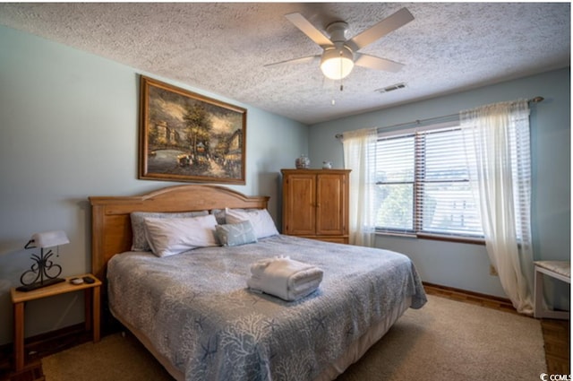 4806 S Ocean Blvd, Surfside Beach, SC 29575 - bedroom featuring a textured ceiling and a ceiling fan