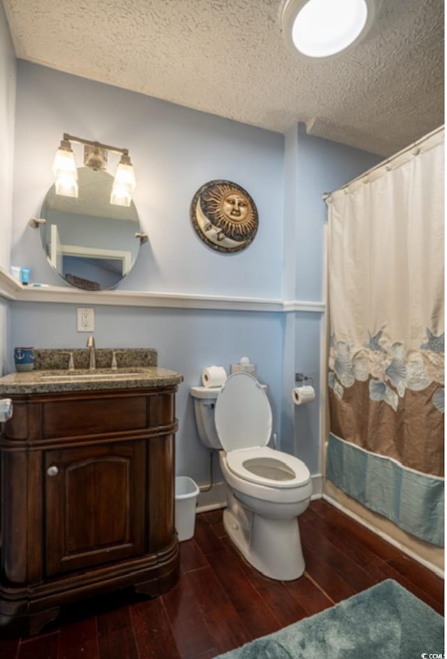 4806 S Ocean Blvd, Surfside Beach, SC 29575 - full bath with hardwood / wood-style flooring, a textured ceiling, vanity, and a shower with curtain
