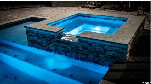 4806 S Ocean Blvd, Surfside Beach, SC 29575 - swimming pool featuring an in-ground hot tub