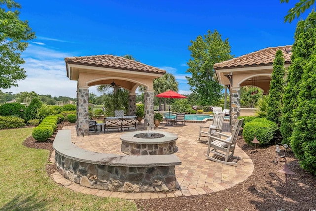 9737 Catalonia Ct, Myrtle Beach, SC 29579 - view of patio featuring a gazebo, a fire pit, a community pool, and ceiling fan