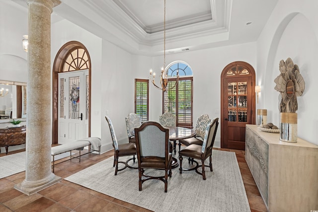 9737 Catalonia Ct, Myrtle Beach, SC 29579 - dining area featuring a chandelier, a tray ceiling, a high ceiling, decorative columns, and crown molding