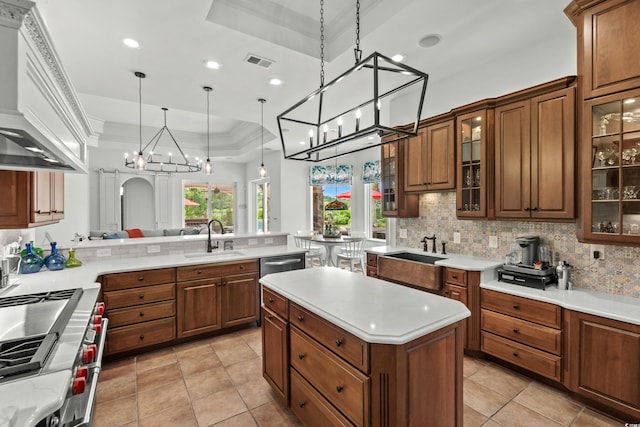 9737 Catalonia Ct, Myrtle Beach, SC 29579 - kitchen featuring a chandelier, tasteful backsplash, light countertops, custom exhaust hood, and a peninsula