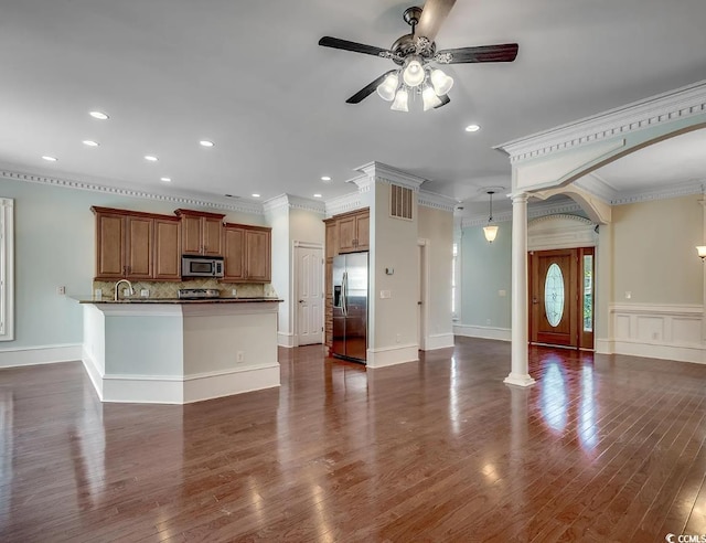 1613 James Island Ave, North Myrtle Beach, SC 29582 - kitchen with stainless steel appliances, ceiling fan, open floor plan, dark countertops, and brown cabinetry