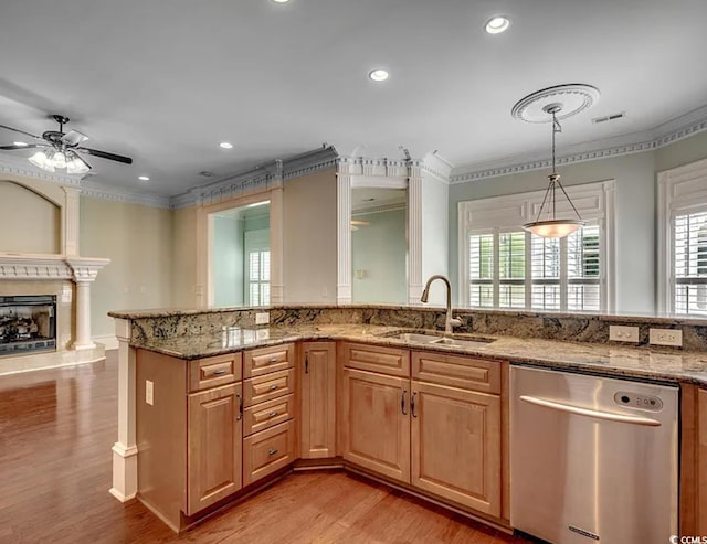 1613 James Island Ave, North Myrtle Beach, SC 29582 - kitchen with stainless steel dishwasher, ornamental molding, healthy amount of natural light, light wood finished floors, and light stone countertops