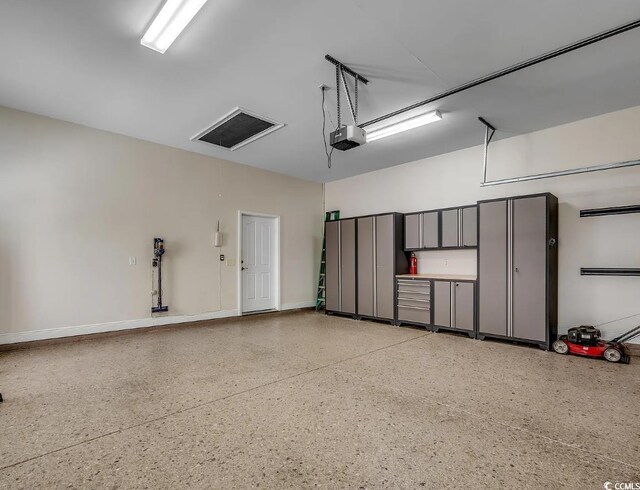 1613 James Island Ave, North Myrtle Beach, SC 29582 - garage featuring a garage door opener and baseboards