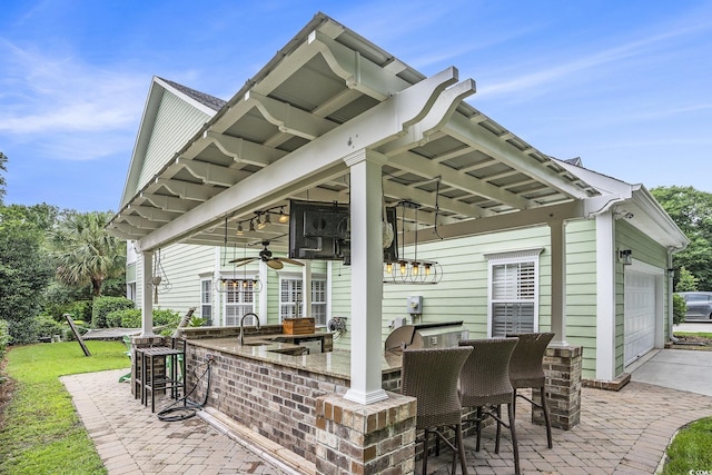 1613 James Island Ave, North Myrtle Beach, SC 29582 - view of patio / terrace featuring a garage, an outdoor kitchen, and a ceiling fan