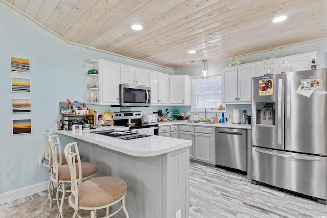 10071 Kings Rd, Myrtle Beach, SC 29572 - kitchen with stainless steel appliances, wood ceiling, a peninsula, recessed lighting, and a breakfast bar area