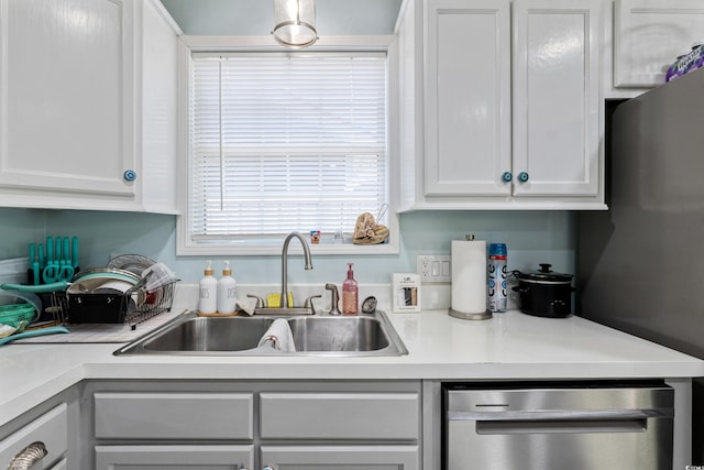10071 Kings Rd, Myrtle Beach, SC 29572 - kitchen with stainless steel dishwasher, light countertops, and white cabinetry