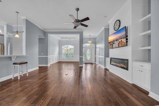 760 Carolina Farms Blvd, Myrtle Beach, SC 29579 - unfurnished living room with ornamental molding, dark wood finished floors, ceiling fan, a glass covered fireplace, and built in features