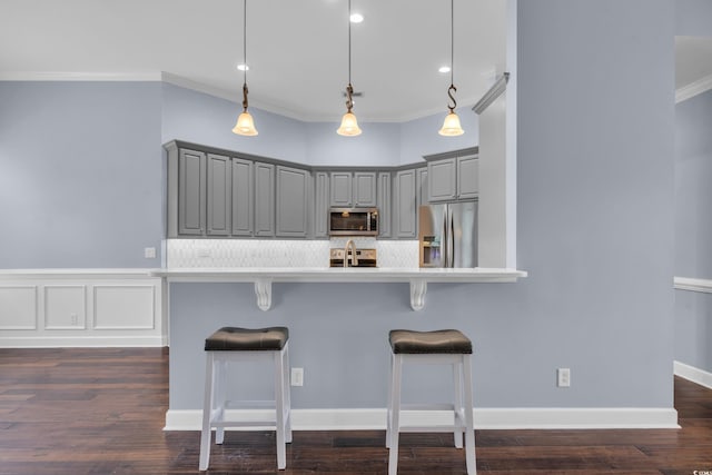760 Carolina Farms Blvd, Myrtle Beach, SC 29579 - kitchen featuring gray cabinets, stainless steel appliances, ornamental molding, a breakfast bar, and light countertops