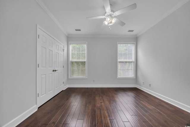 760 Carolina Farms Blvd, Myrtle Beach, SC 29579 - unfurnished bedroom with multiple windows, dark wood-style flooring, crown molding, ceiling fan, and a closet