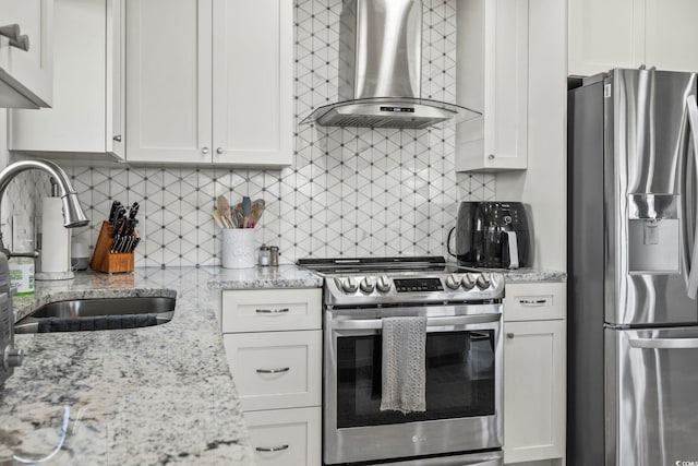 1663 Harbor Dr, North Myrtle Beach, SC 29582 - kitchen featuring stainless steel appliances, exhaust hood, decorative backsplash, and white cabinetry