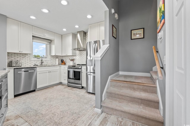 1663 Harbor Dr, North Myrtle Beach, SC 29582 - kitchen with appliances with stainless steel finishes, wall chimney exhaust hood, light stone countertops, decorative backsplash, and recessed lighting