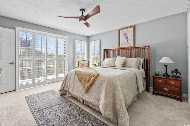 1663 Harbor Dr, North Myrtle Beach, SC 29582 - bedroom featuring light carpet, access to outside, a textured ceiling, and ceiling fan