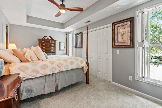 1663 Harbor Dr, North Myrtle Beach, SC 29582 - bedroom featuring carpet flooring, a tray ceiling, a ceiling fan, and a closet