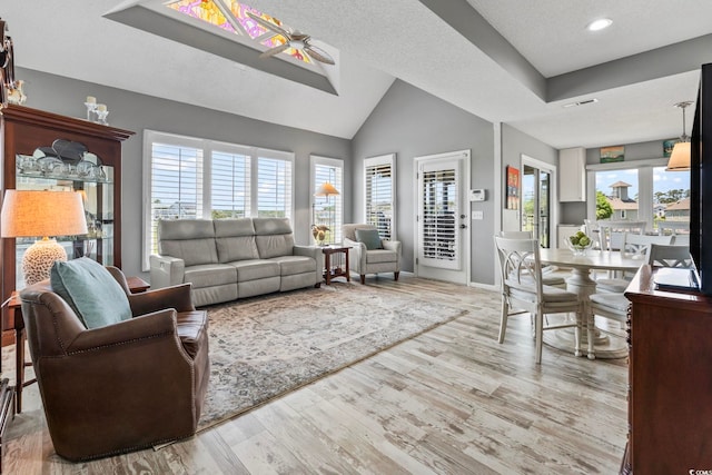1663 Harbor Dr, North Myrtle Beach, SC 29582 - living room with wood finished floors, plenty of natural light, vaulted ceiling, and recessed lighting