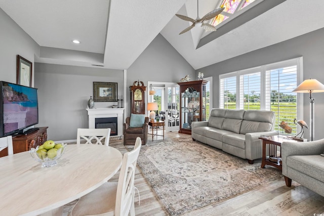 1663 Harbor Dr, North Myrtle Beach, SC 29582 - living room featuring wood finished floors, a glass covered fireplace, ceiling fan, high vaulted ceiling, and recessed lighting